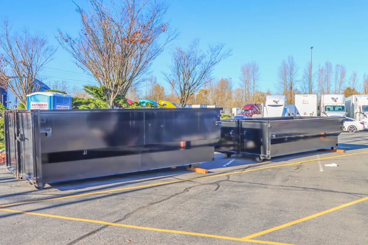 Professional dumpster rental service with roll-off container on residential driveway in Holly Hill